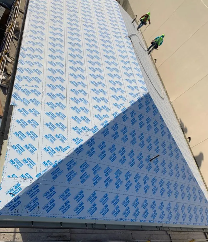 Professional roofers installing underlayment on a metal roof in Hamburg